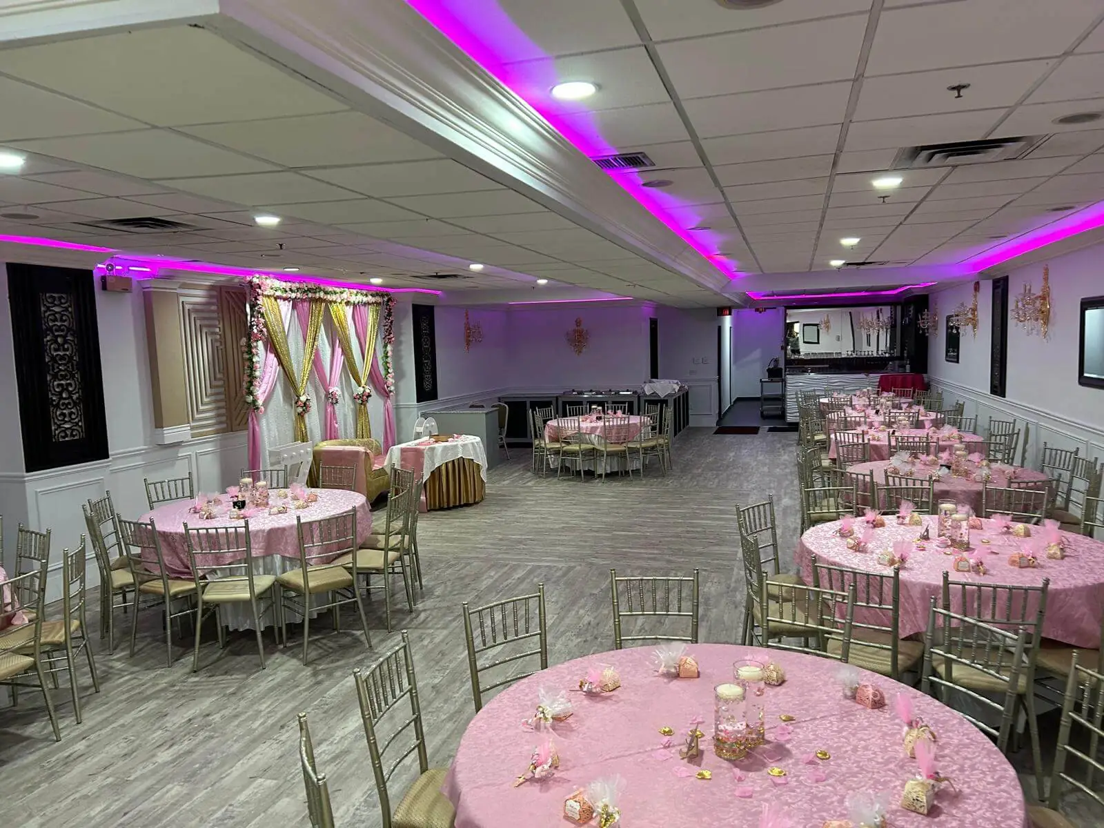 The Junior Ballroom in pink lighting, set for a shower or birthday party.