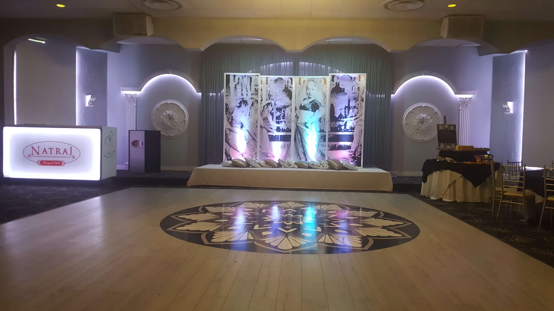 Inlaid dance floor pattern picked out by overhead lighting.