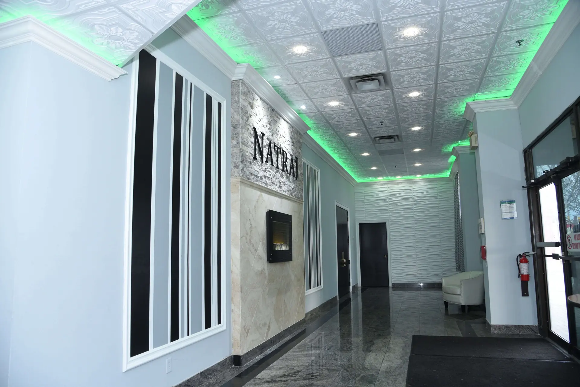 Entrance hallway lit in green for an evening event.