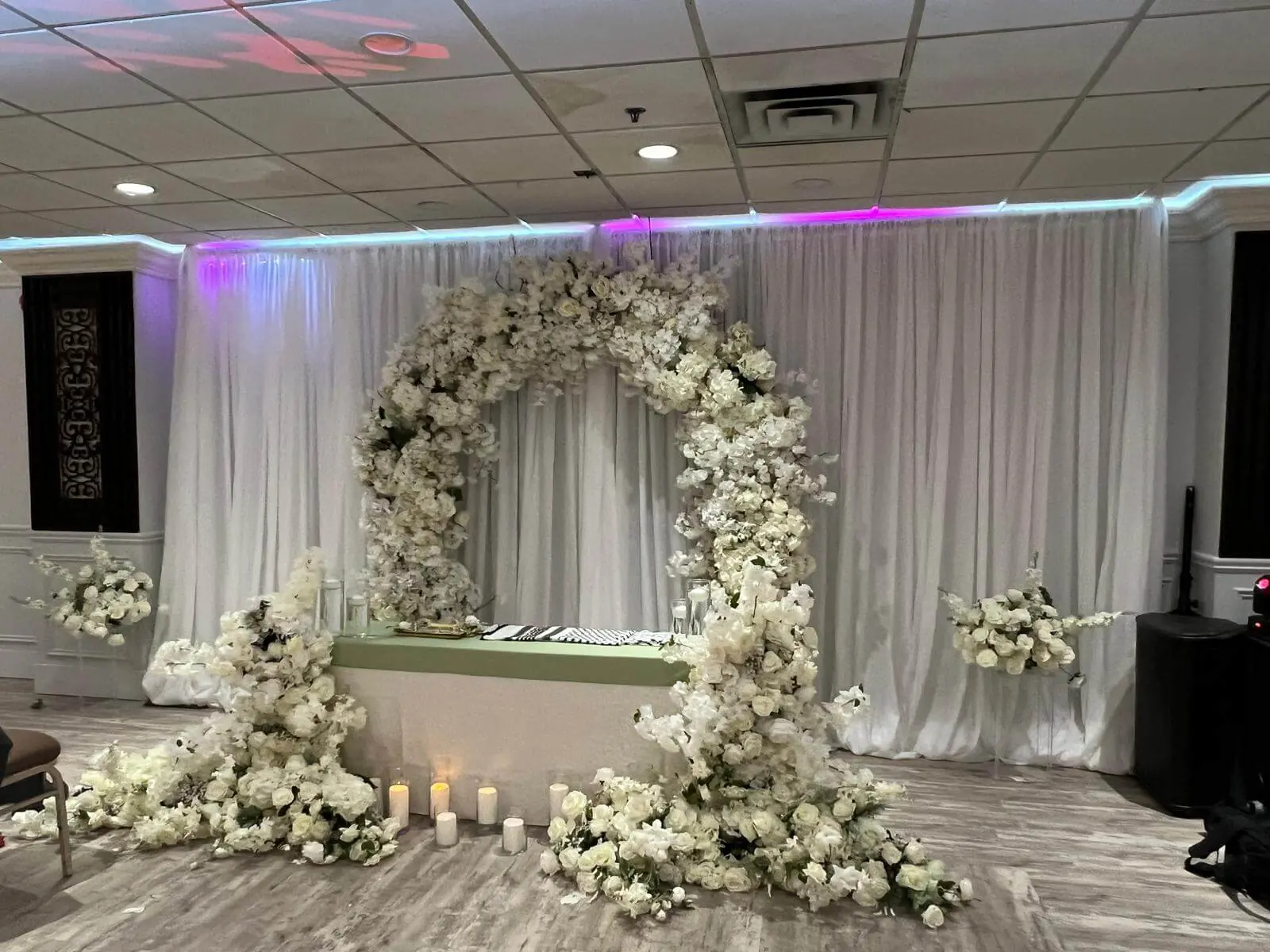 Floral arch used as a ceremony backdrop.