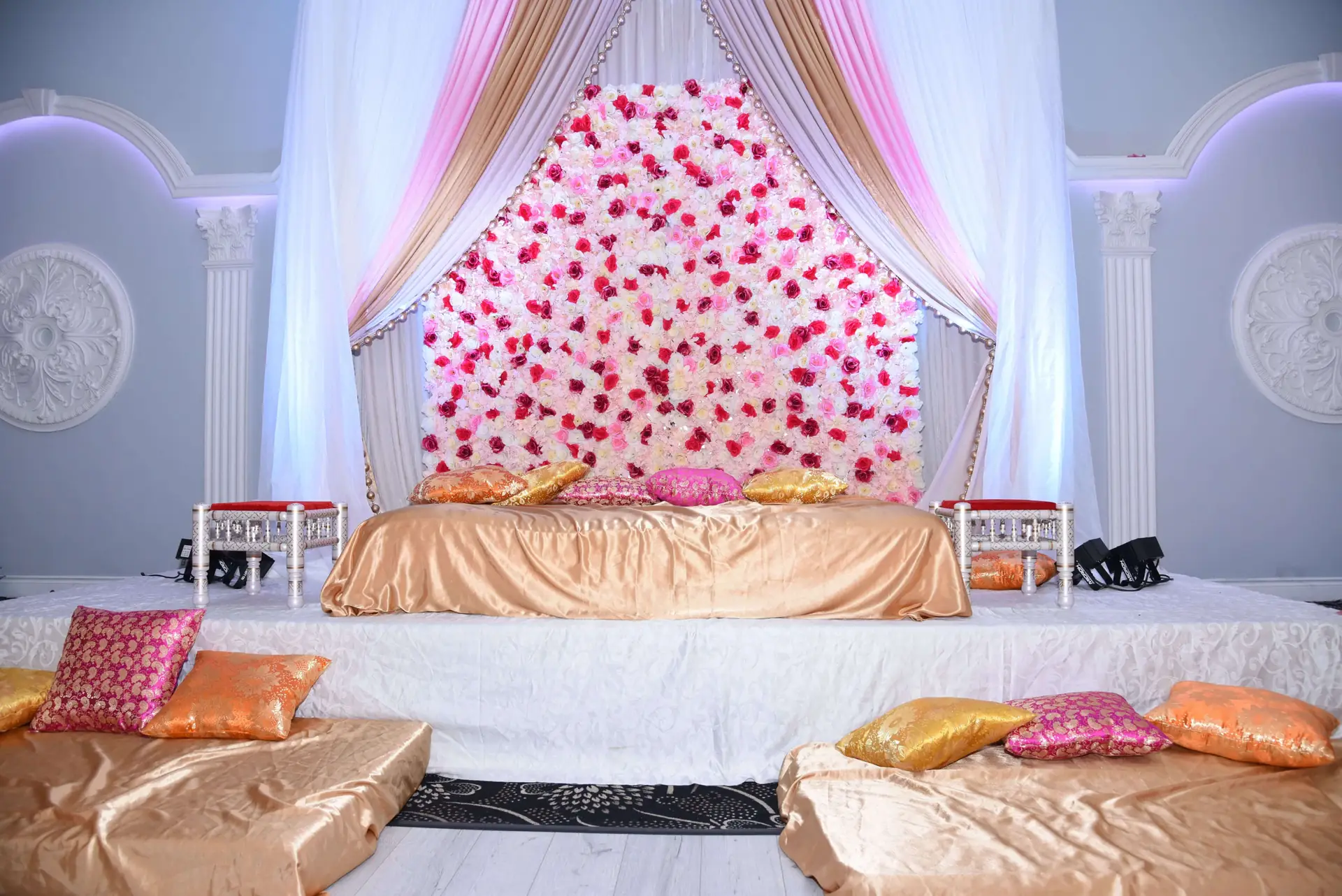Floral mandap framing the entrance to the ceremony.