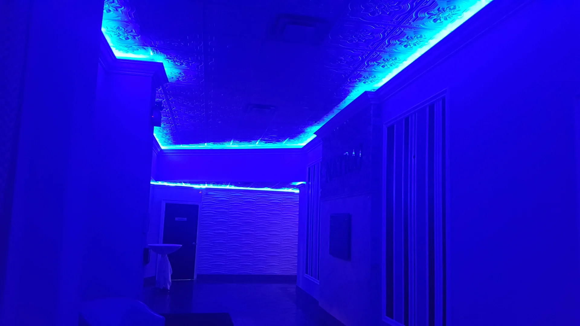 Corridor lighting set to blue along the approach to the Grand Ballroom.