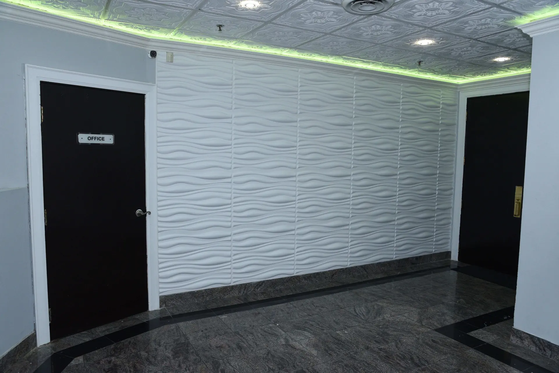 Wave-panelled corridor wall leading toward the ballrooms.