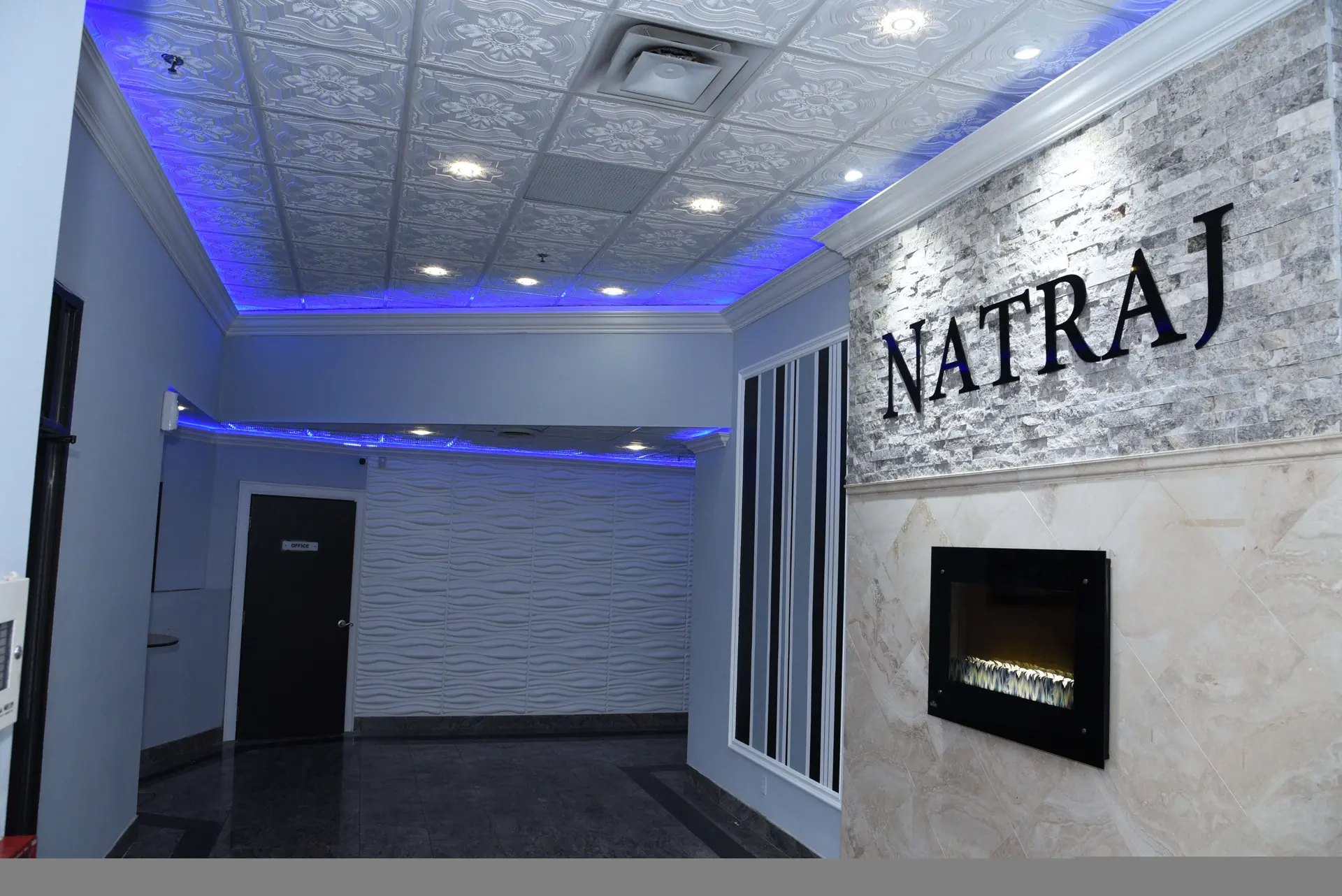 Wide view of the lobby lounge and its fireplace.