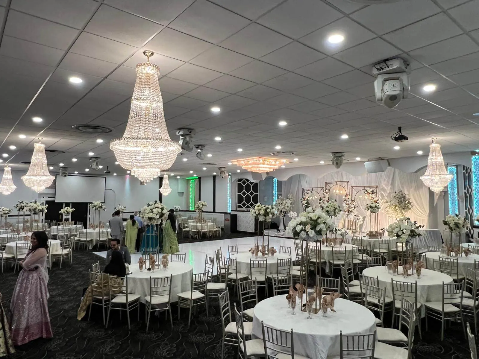 Ceiling-to-floor white draping across the Grand Ballroom walls, softening the room for a wedding.