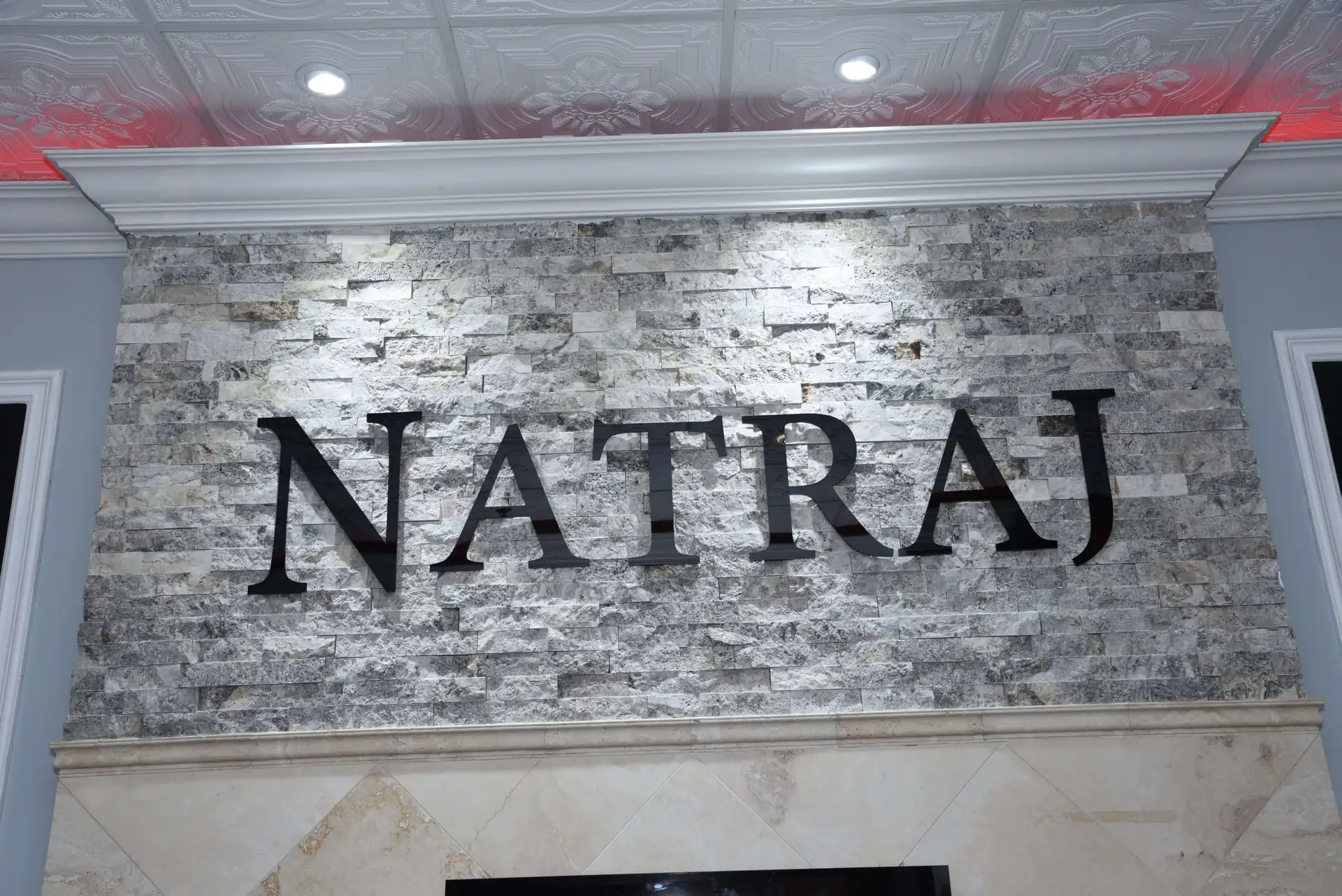 The Natraj name mounted on a feature wall inside the venue.