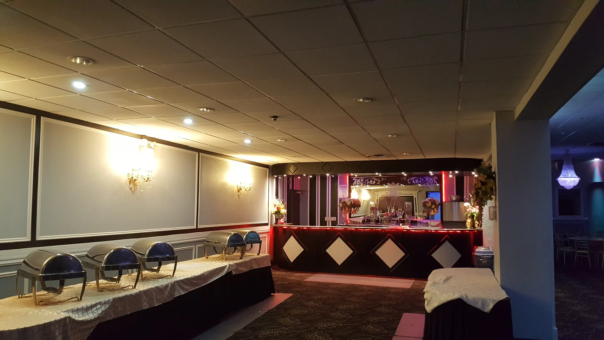 Stage under deep red lighting during an evening reception.