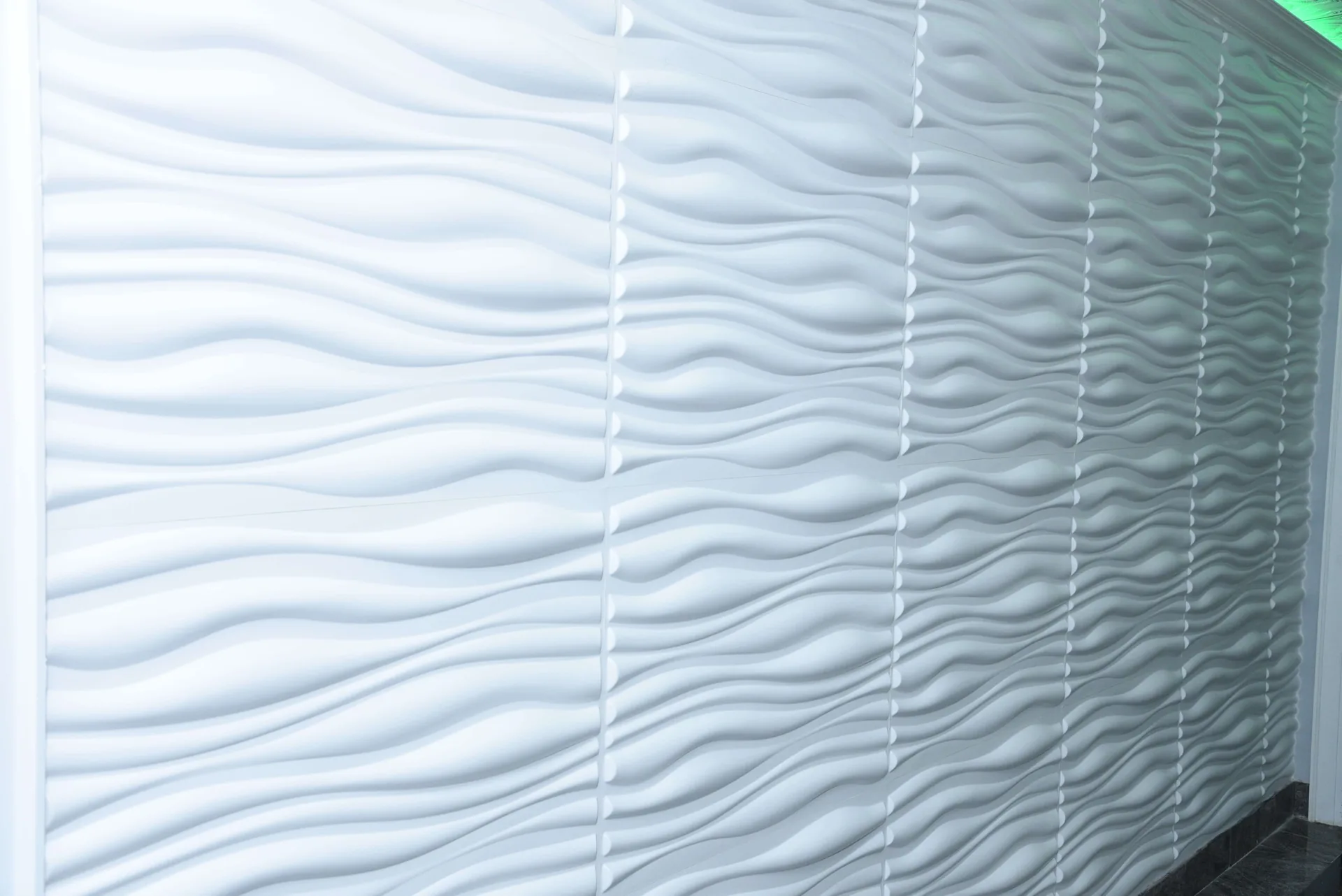 Sculpted wave panelling detail on an interior wall.